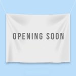 Image of a fabric banner wtih "coming soon" printed on it