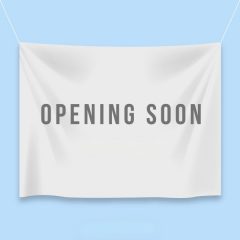 Image of a fabric banner wtih "coming soon" printed on it